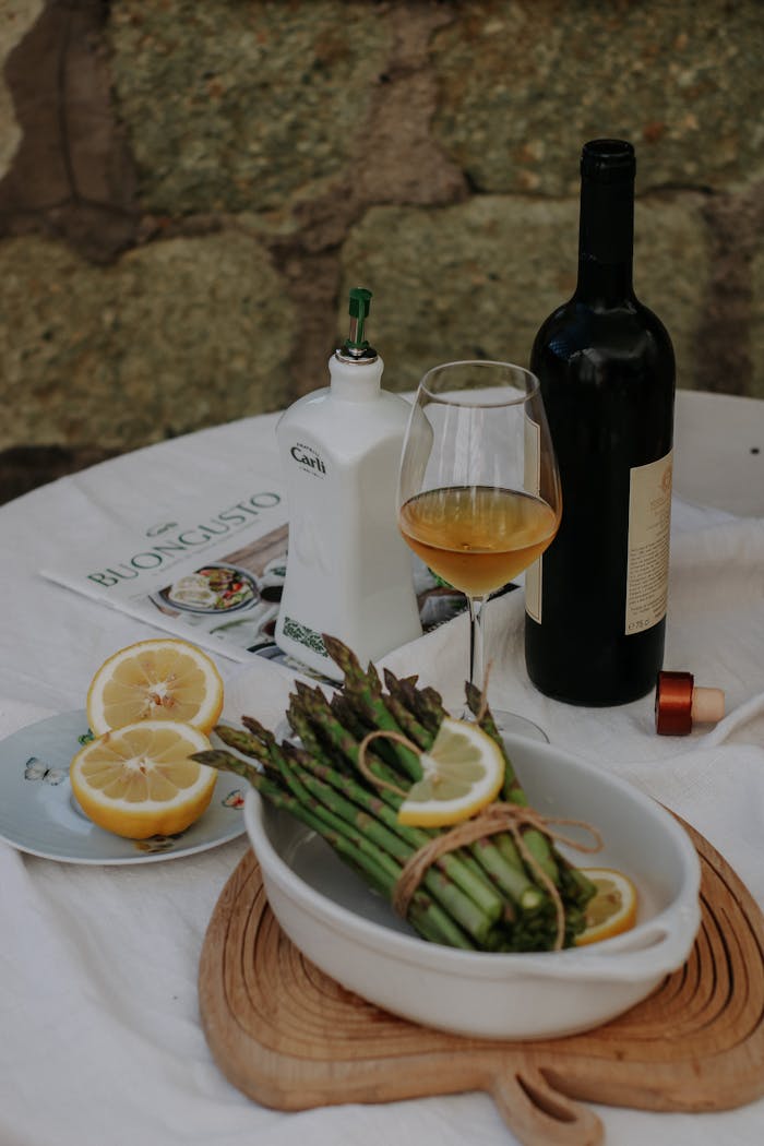 Asparagus with Lemon and Wine on Table